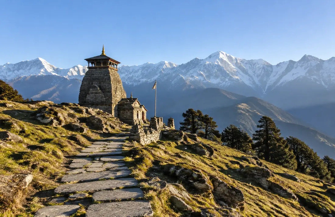 Stone temple and trail near Chopta with snow-covered Garhwal peaks