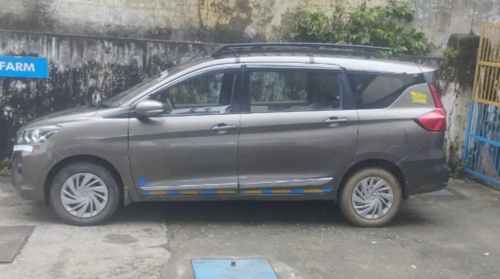 Grey Maruti Ertiga with roof luggage carrier