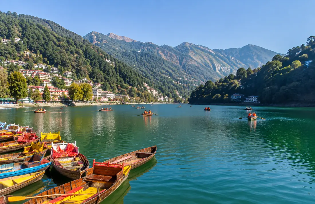 Colorful boats on Naini Lake surrounded by Nainital hills